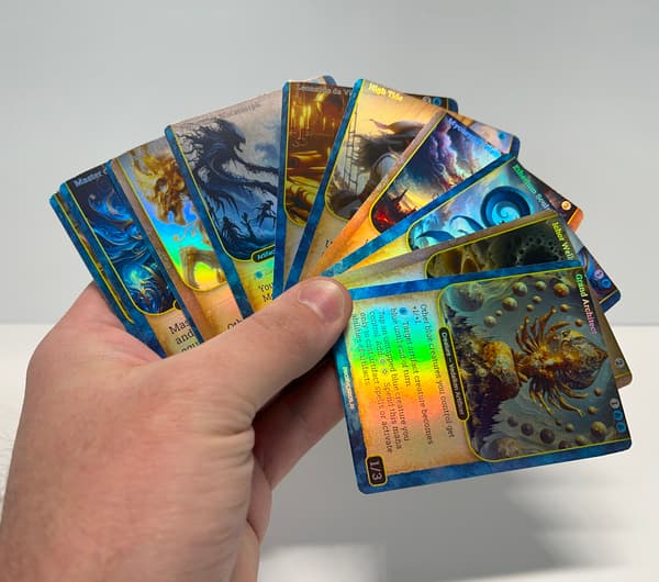 Hand holding a fan of rainbow foil MTG proxy cards